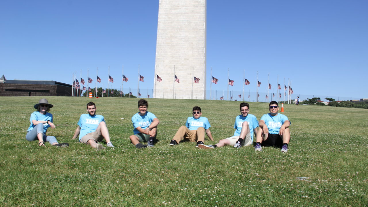 Alumni Sitting Near the Washington Monument on the National Mall