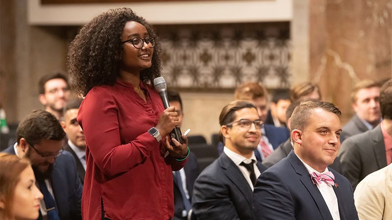 A student asking a question during a guest lecture.