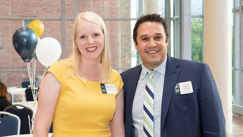 A student pictured with an alumnus providing career advice.