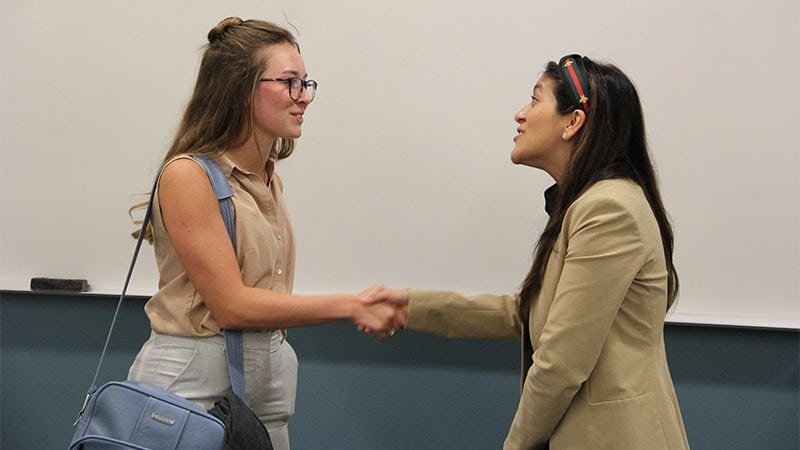 Student meeting speaker after professional development session