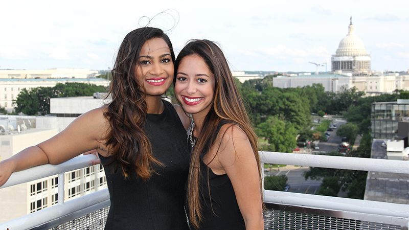 Students on a rooftop overlooking the U.S. Capitol Building.