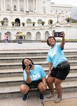 Students taking a selfie in front of the Capitol Building.