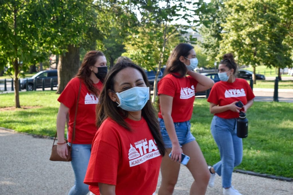 Masked students walking near the Capitol