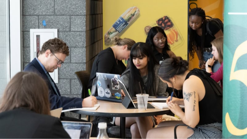 Students working in a group before class at George Mason University. 